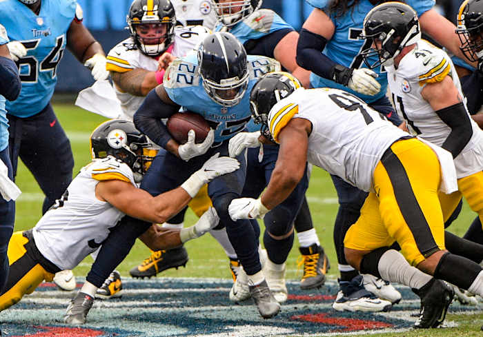 Derrick Henry runs through a crowd against the Steelers